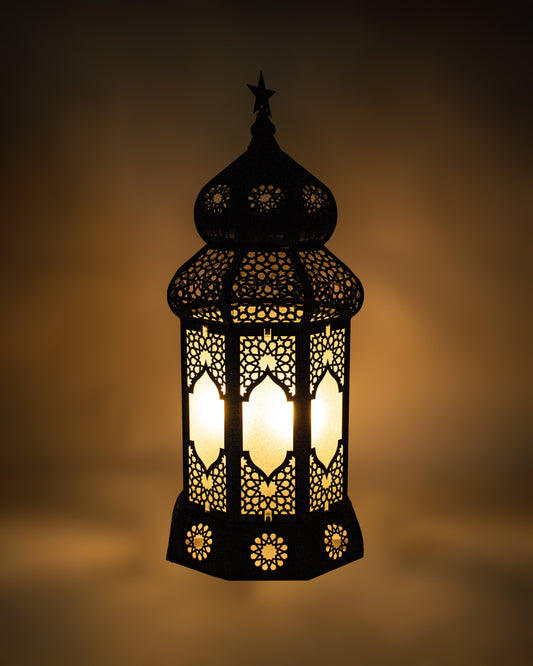 Decorative Ramadan lantern with intricate cut-out patterns on a dark background
