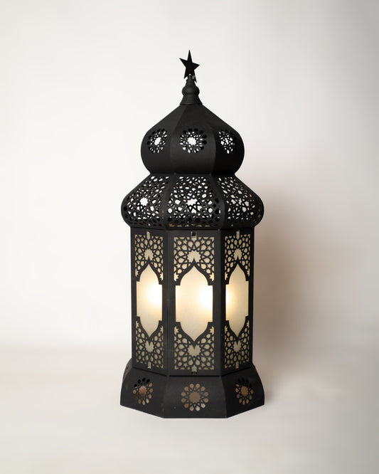 Black ornate Ramadan  lantern with cut-out patterns on a white background