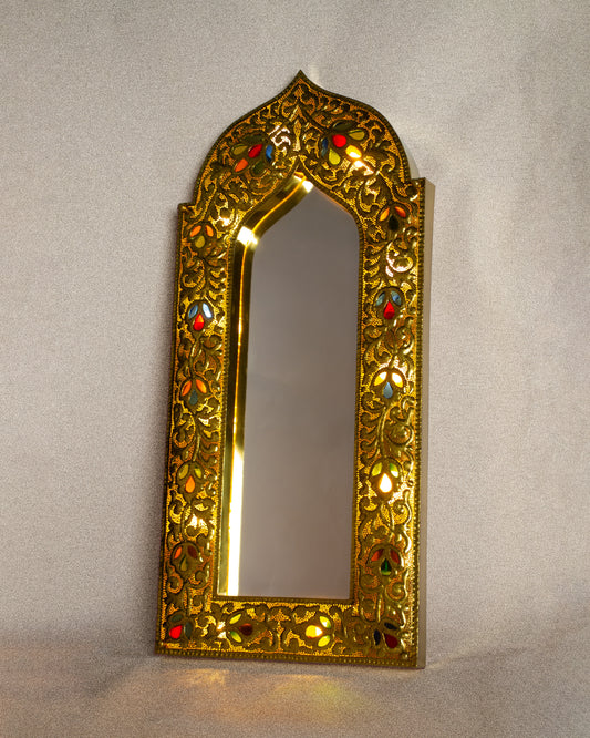 Decorative Hand-Hammered  gold mirror with Glass inlay accents on a plain background